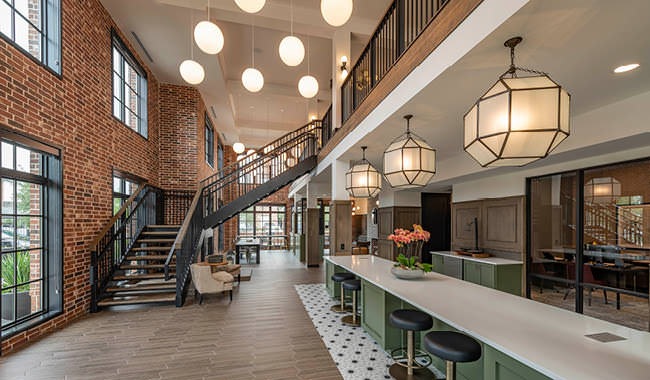 clubhouse kitchen with stylized lighting and staircase